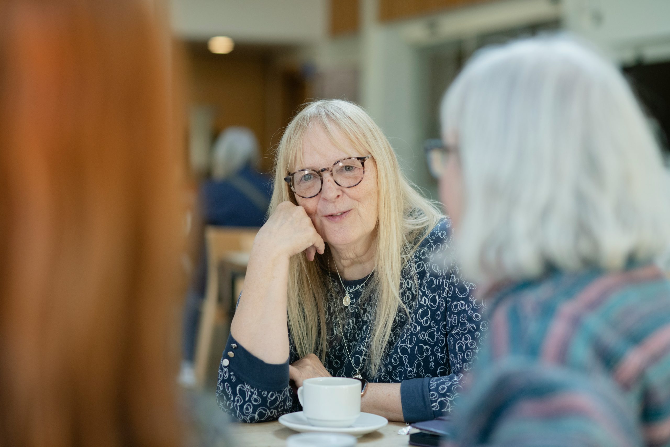 senior woman in conversation with tea