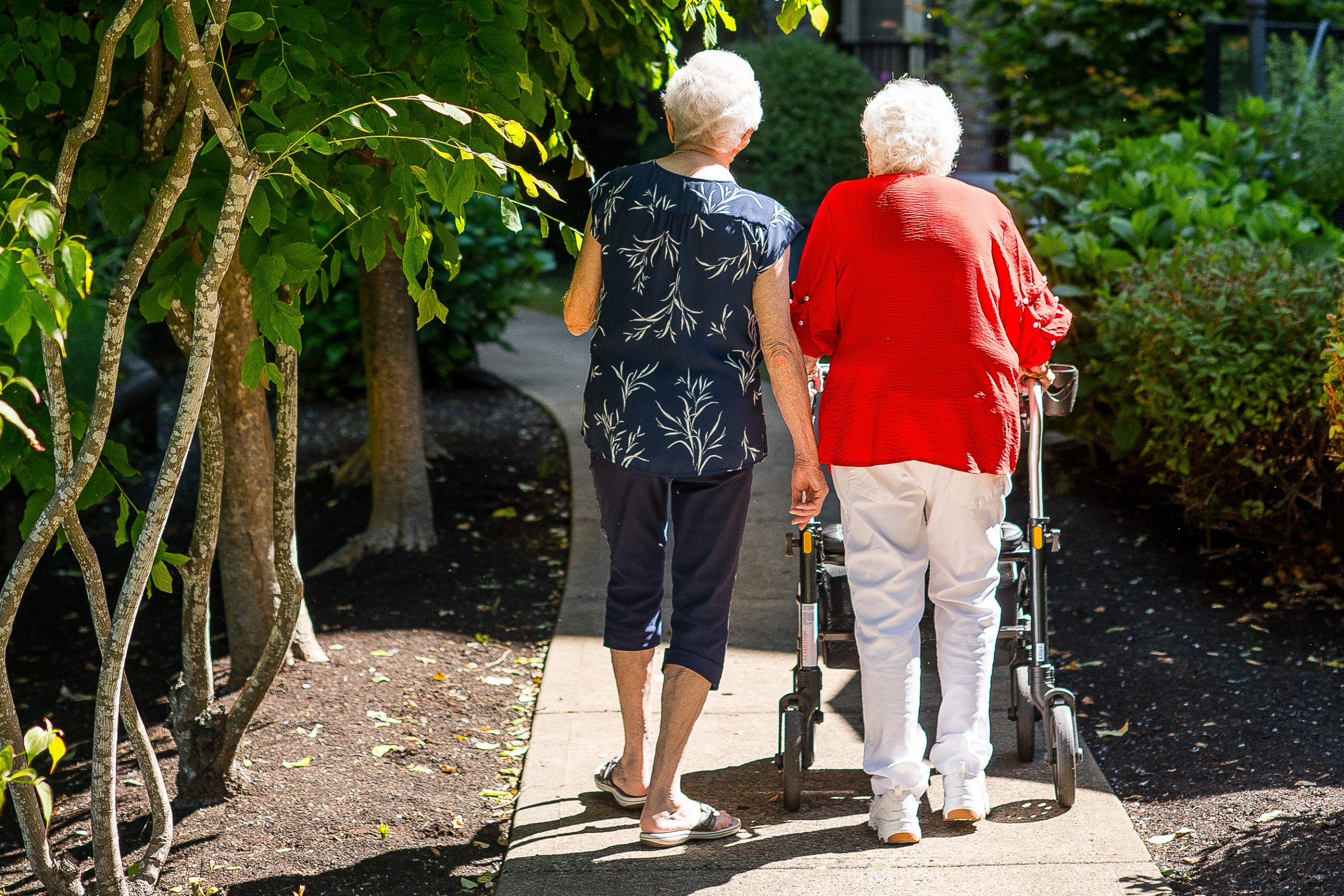 squamish seniors walking away in garden
